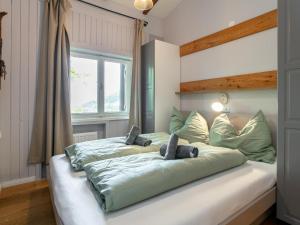a bed with two stuffed animals on top of it at MAYR 74 in Wörgl