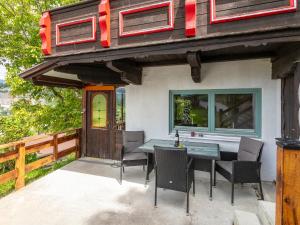 a house with a table and chairs on a patio at MAYR 74 in Wörgl