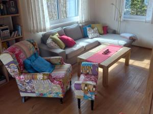 a living room with a couch and a table and chairs at Landhaus Alpenblick Tauplitz in Tauplitz