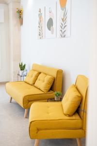 two mustard colored couches in a living room at Le Volte in Lizzano