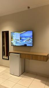 a flat screen tv hanging on a wall at Alassaf 304 in Sīdī Ḩamzah