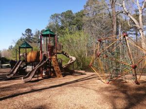 a playground with two slides and a swing set at Cozy ATL Suite with Kitchenette in Atlanta