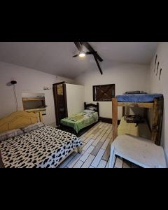 a room with two beds and a ceiling fan at Regional Park in Rafard