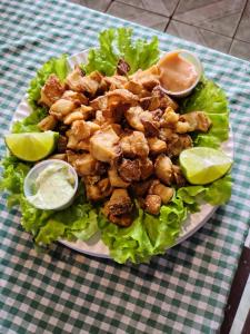 a plate of food with chicken lettuce and sauce at Regional Park in Rafard