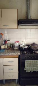 a kitchen with a stove with pots and pans on it at Casa amigable dos habitaciones cuatro lugares in Rosario