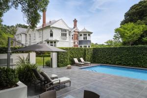 a swimming pool in front of a house at Otahuna Lodge in Christchurch