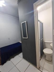 a bathroom with a toilet and a sink at Pousada econômica puc in Porto Alegre