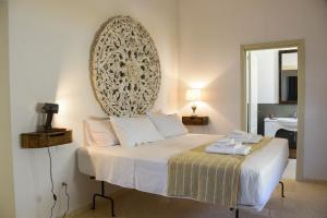 a bedroom with a bed with a large mirror on the wall at Assunta Affittacamere in Vitigliano