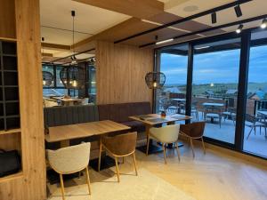 a restaurant with wooden walls and tables and chairs at Hotel O2 Tornik in Ribnica