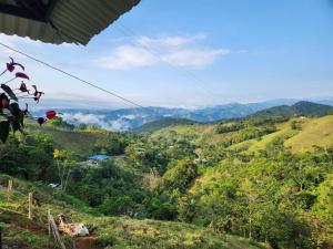 a view of a mountain valley with clouds in the distance at Alojamiento Las Rocas in Confines
