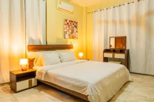 a bedroom with a large bed and a television at MAAT Luxury Homes in Accra