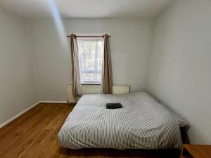 a bed in a room with a window at East Croydon Train Station in Croydon