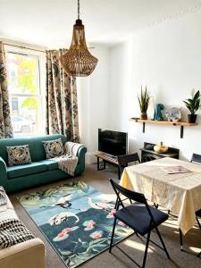 a living room with a green couch and a table at St Leonards in Hollington