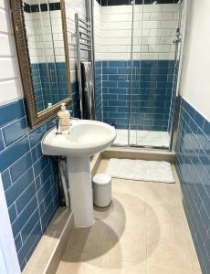 a bathroom with a sink and a shower at St Leonards in Hollington