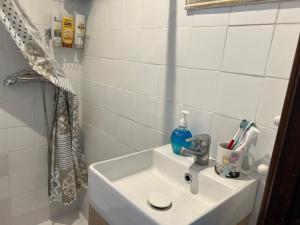 a bathroom with a sink and a shower at La Cabaña del aviador in Feás +46 photos