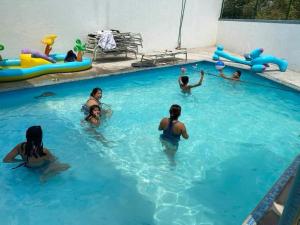 a group of people playing in a swimming pool at Quinta Kendriel in Tezoyuca