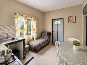 a kitchen and living room with a table and a couch at Serenity Escape, Cozy Stay w Secure Parking in Runaway Bay