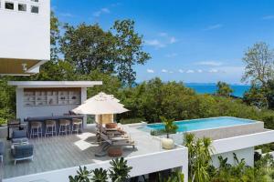 a villa with a swimming pool and a patio at Mee Kham Sook Luxury Villa in Nathon Bay