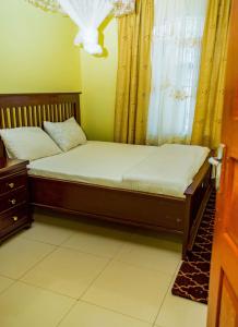 a small bed in a room with a window at The new home in Moshi