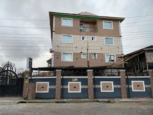 a tall brick building on the side of a street at Diamond Groove Hotel & Suites in Sangotedo