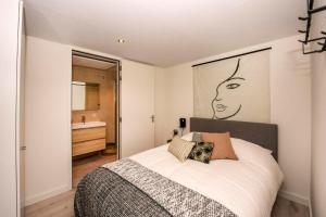 a bedroom with a bed with a large picture on the wall at Forest Cube 2 persons #628 2 persoons in Maasbree