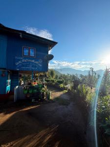 a shop on the side of a house on a dirt road at Chintapu Homestay In Maipokhari, Sandakpur Ilam in Ilām