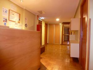 an office corridor with a door leading to a hallway at Pensión Romero in Oviedo