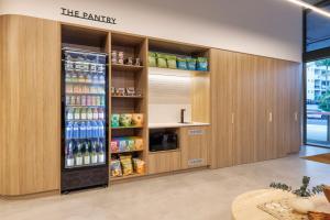 a drink station in a store with a large refrigerator at Quest Southport in Gold Coast