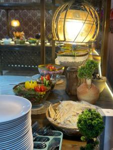 a table topped with plates and bowls of food at Mirthe rum in Disah +18 photos