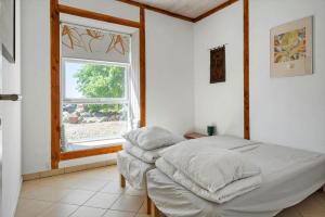 a bedroom with a bed and a window at 6048-Stege-Kostervej-48 in Stege