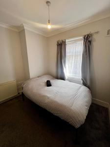 a small bedroom with a bed with a window at East Croydon Train Station in Croydon