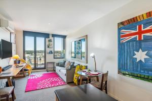 a living room with a couch and a table at Seaside Studio Apartment in Frankston, Melbourne in Frankston +22 photos