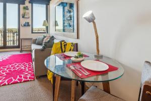 a living room with a glass table and a couch at Seaside Studio Apartment in Frankston, Melbourne in Frankston