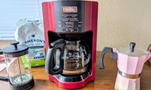 a red and black coffee maker on a counter at By State Fair 5 bedrooms 2 baths in Des Moines