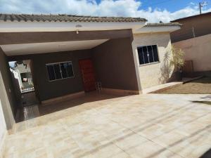 a house with a garage with a red door at Casa com Ar-Condicionado in Formosa