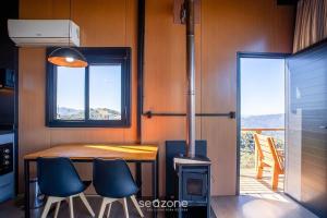 a kitchen with a table and chairs and a stove at Charming chalet with fireplace and hot tub! VST045 in Annitapolis +20 photos