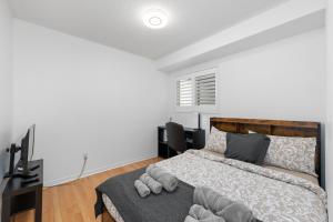 a bedroom with a bed and two chairs in it at Semi-Private Townhouse - 3 Bedrooms, 4 beds, Free Parking, Wifi, Netflix, - Hosted by Matthew in Toronto
