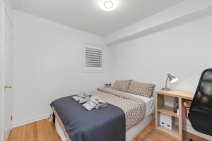 a bedroom with a bed and a desk with a tv at Semi-Private Townhouse - 3 Bedrooms, 4 beds, Free Parking, Wifi, Netflix, - Hosted by Matthew in Toronto +30 photos