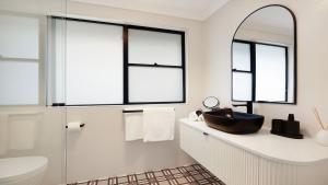 a bathroom with a sink and a mirror at Mirambeena in Berrima +24 photos