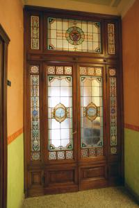 a large wooden door with stained glass windows at Hotel Desirèe in Florence