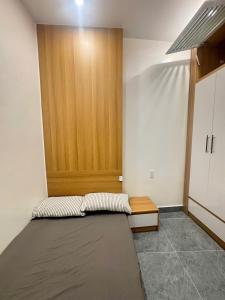 a room with a bed and a wooden door at ALUC 2 HOUSE CatBa in Cat Ba