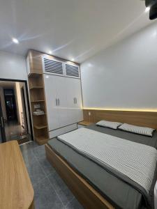 a bedroom with a large bed and a closet at ALUC 2 HOUSE CatBa in Cat Ba
