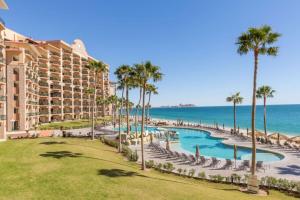 an aerial view of a resort with palm trees and a swimming pool at Ground Floor Sonoran Sea 112-W in Puerto Peñasco