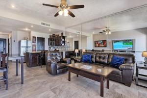 a living room with leather furniture and a ceiling fan at Ground Floor Sonoran Sea 112-W in Puerto Peñasco