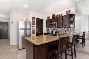 a kitchen with a stainless steel refrigerator and a counter at Ground Floor Sonoran Sea 112-W in Puerto Peñasco