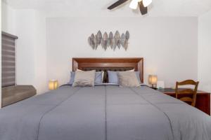 a bedroom with a large bed with a wooden headboard at Ground Floor Sonoran Sea 112-W in Puerto Peñasco +36 photos