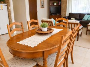 a wooden dining room table with chairs and a table sidx sidx sidx at Seascape Carroll Avenue - close to Mollymook Beach in Mollymook