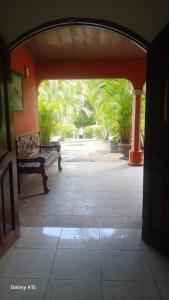 an archway leading to a patio with a bench at Las Colinas in León