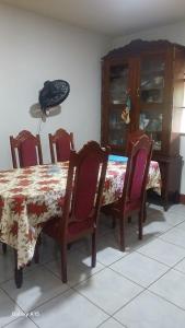 a dining room with a table and chairs and a phone at Las Colinas in León