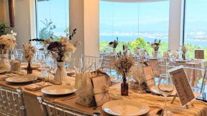 a long table with glasses and flowers on it at Castle View Hotel Resort in Samal